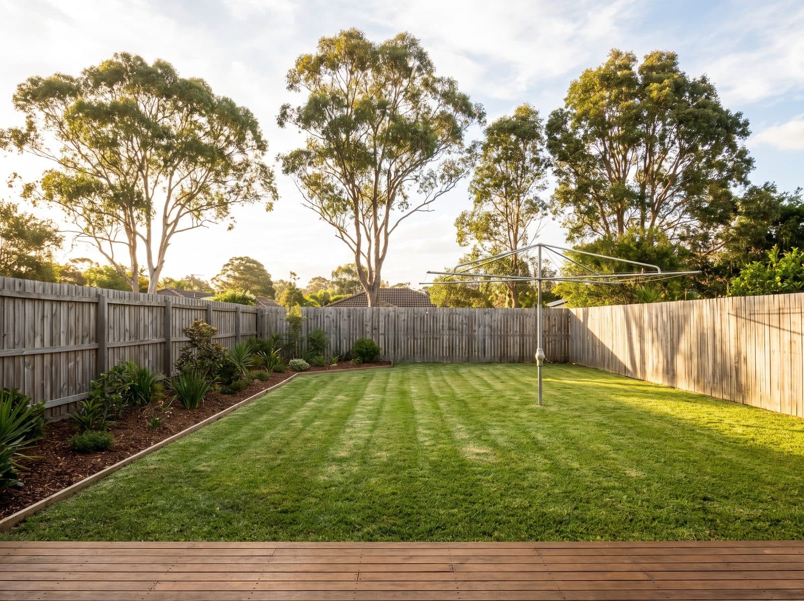 The same backyard after: mowed with stripes, edges cut, clean